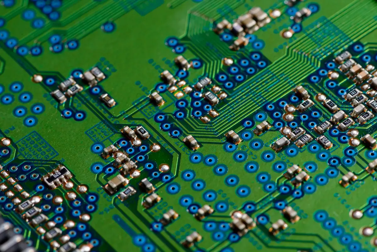 Detailed image of green circuit board showcasing electronic components for technology use.