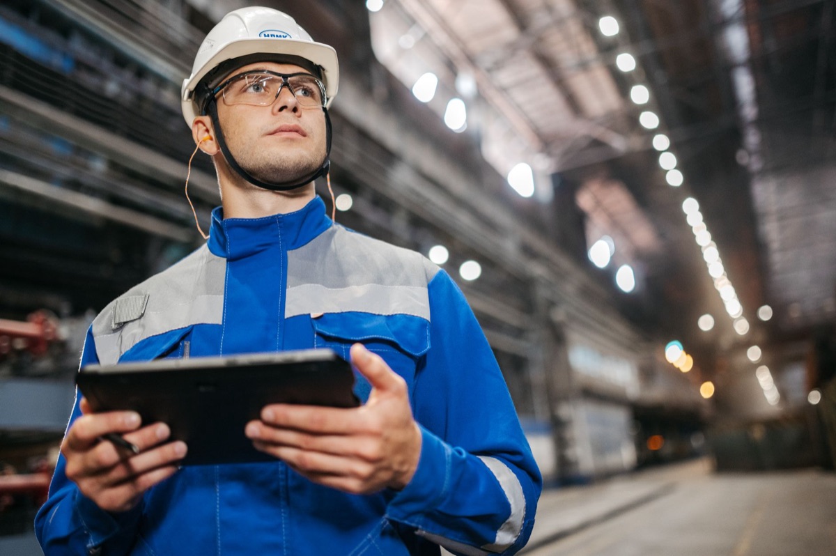 Japanese engineer using AI tablet for semiconductor manufacturing analysis